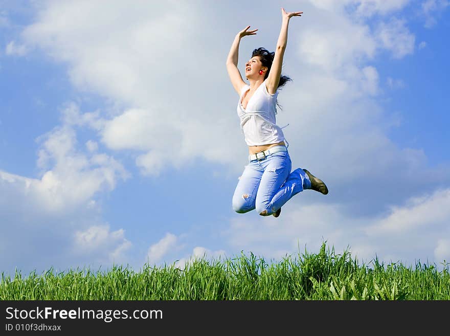 Happy young woman is jumping