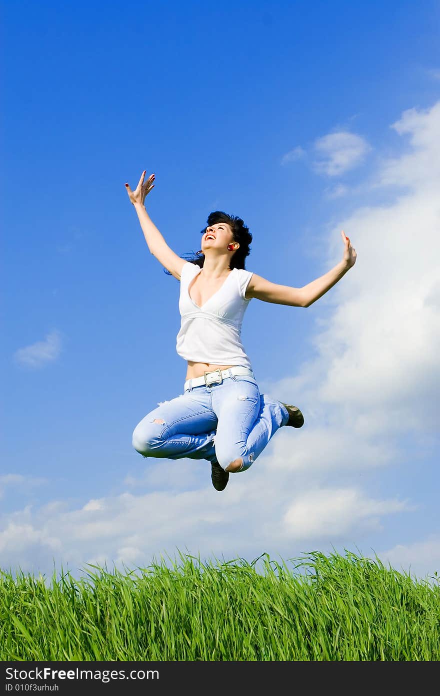 Happy young woman is jumping