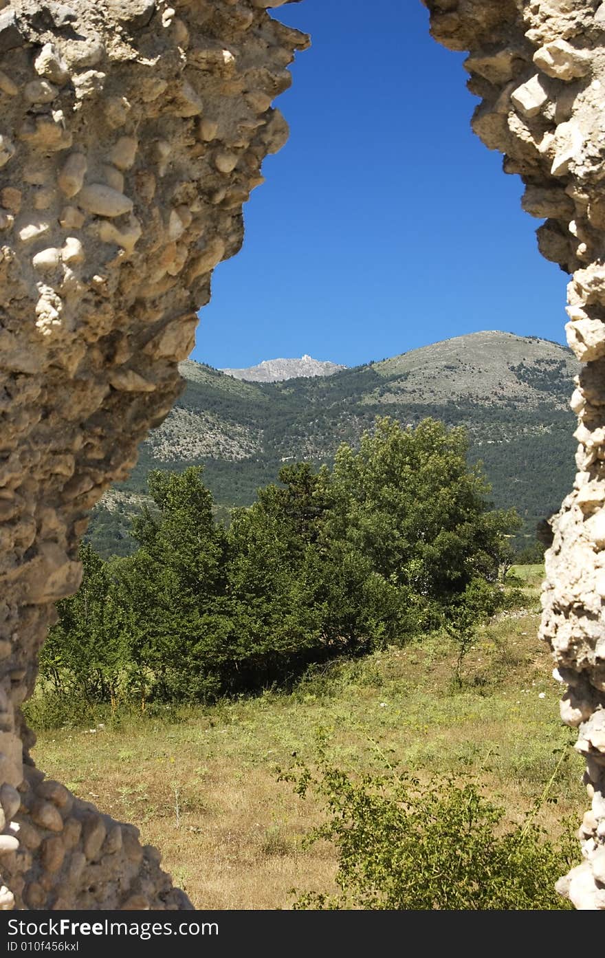 Nature view trough an antique stone wall. Nature view trough an antique stone wall