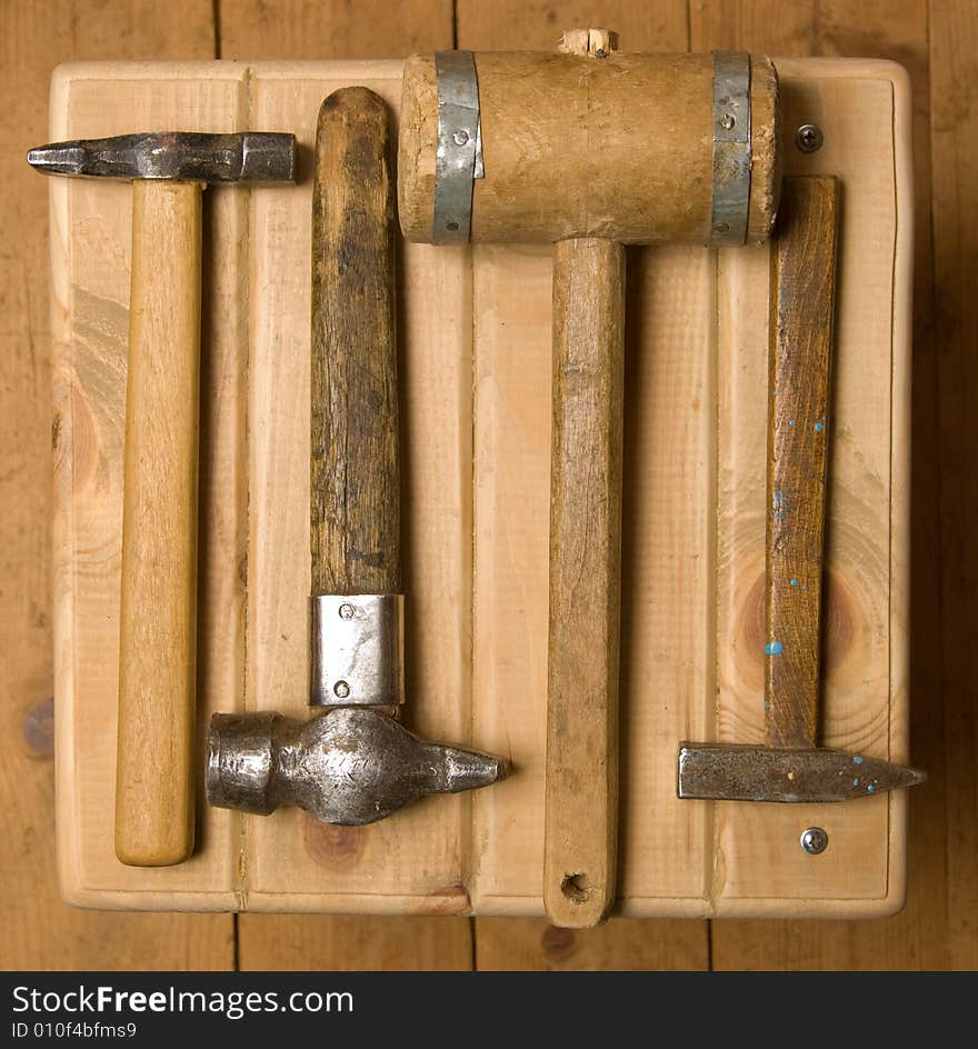 Old hammers. Three hammers and beater.