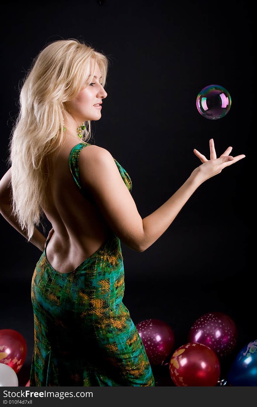 Girl with ballons and bubbles on black background