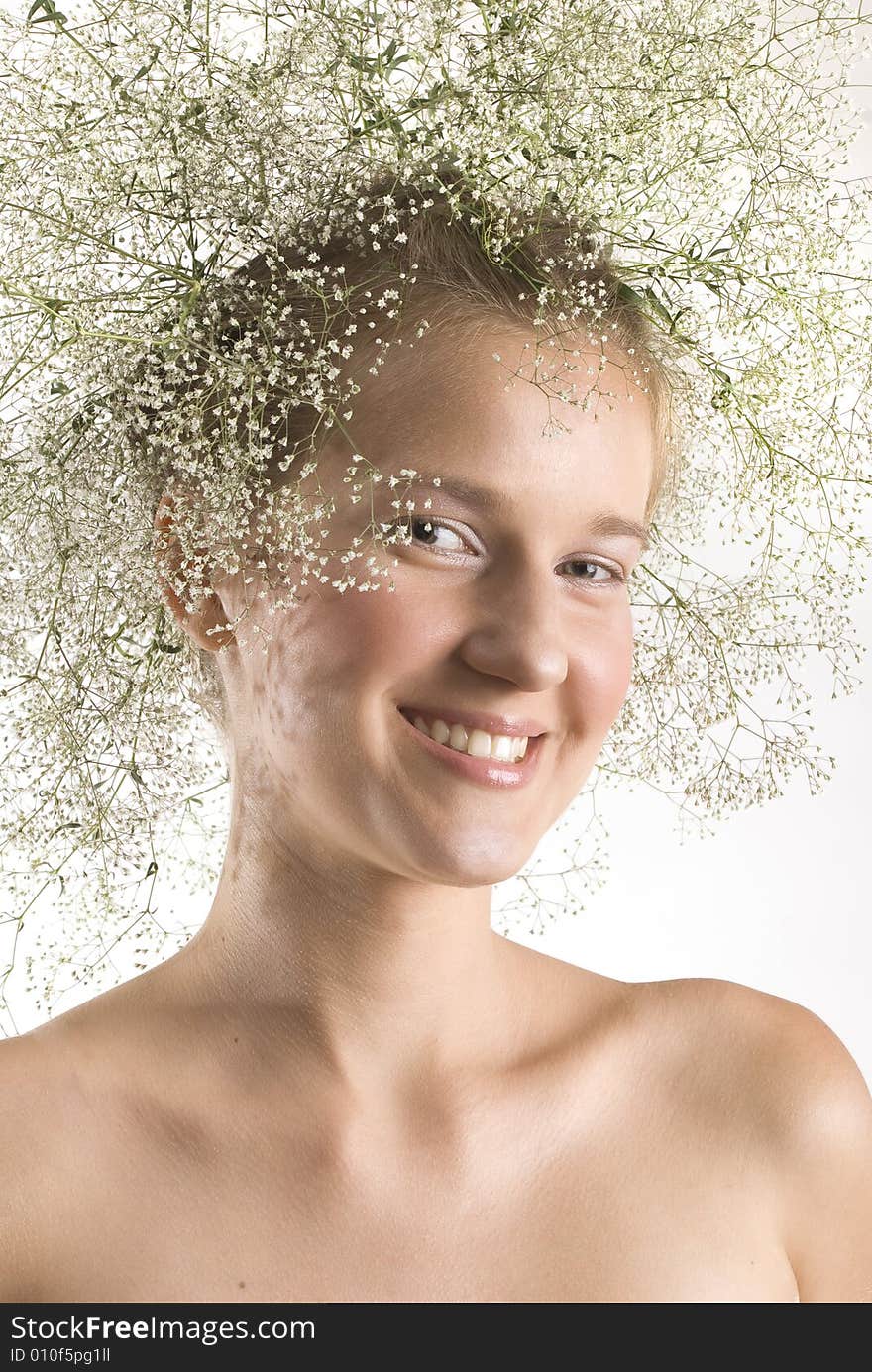 Nice young girl with wreath on her head isolated over white