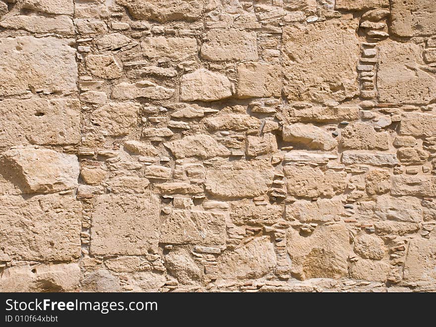 Stone wall from rough sandstone with cement