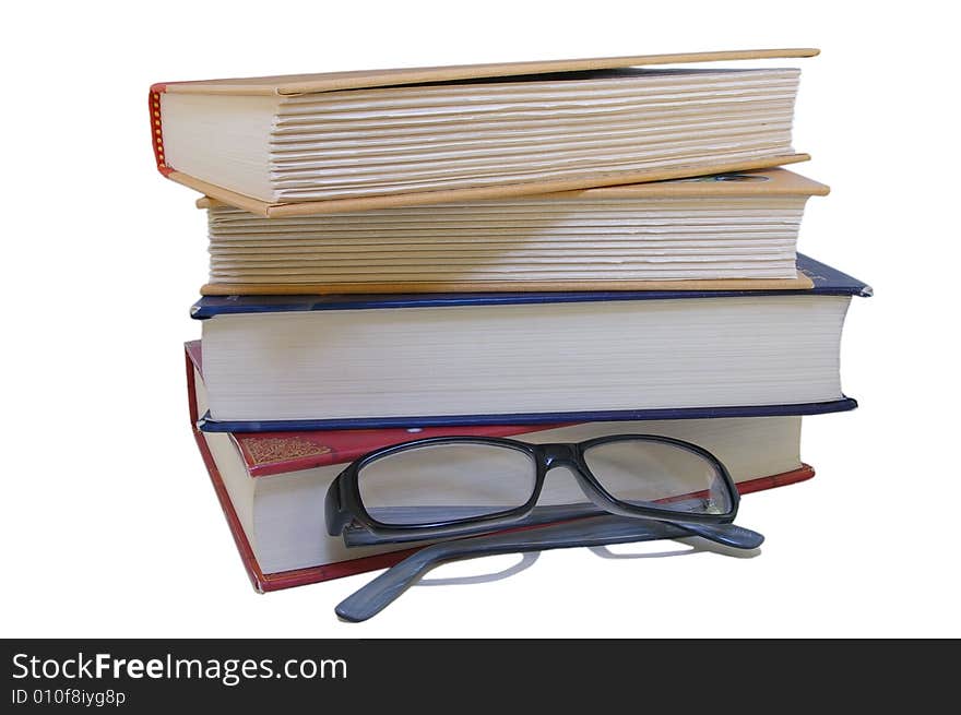 Stack of Books and Pair of Glasses on Isolated white background. Stack of Books and Pair of Glasses on Isolated white background