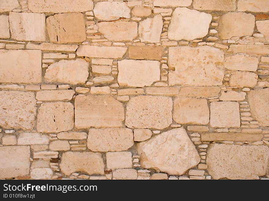 Stone wall from rough sandstone with cement