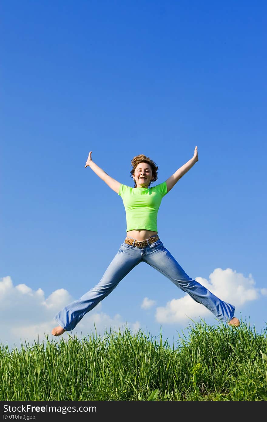 Happy young woman is jumping