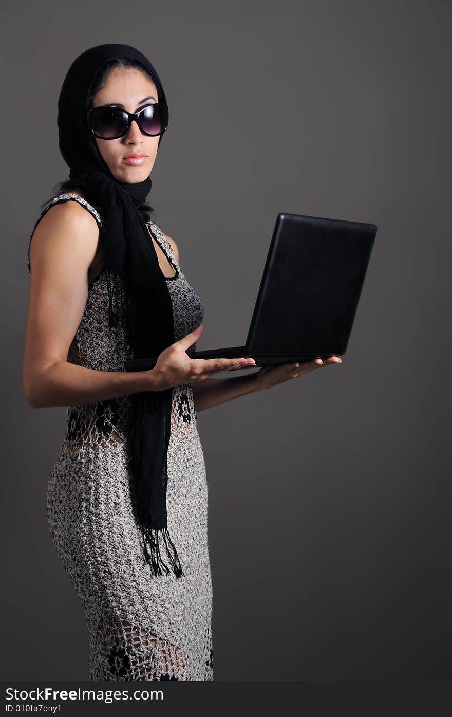 Portrait of young fashion female holding laptop. Portrait of young fashion female holding laptop