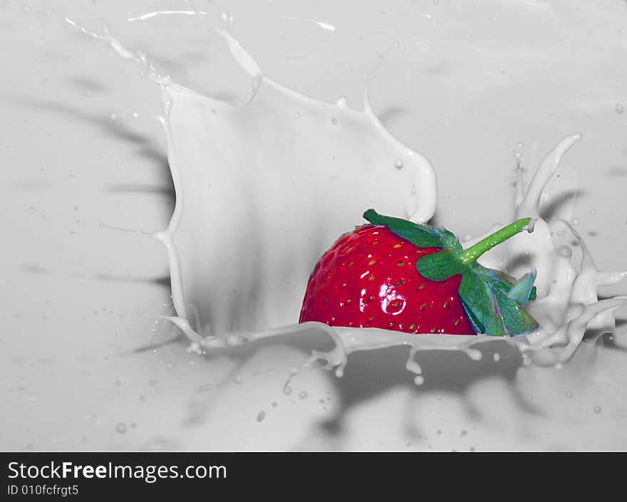 Strawberry falling into creamy milk. Strawberry falling into creamy milk