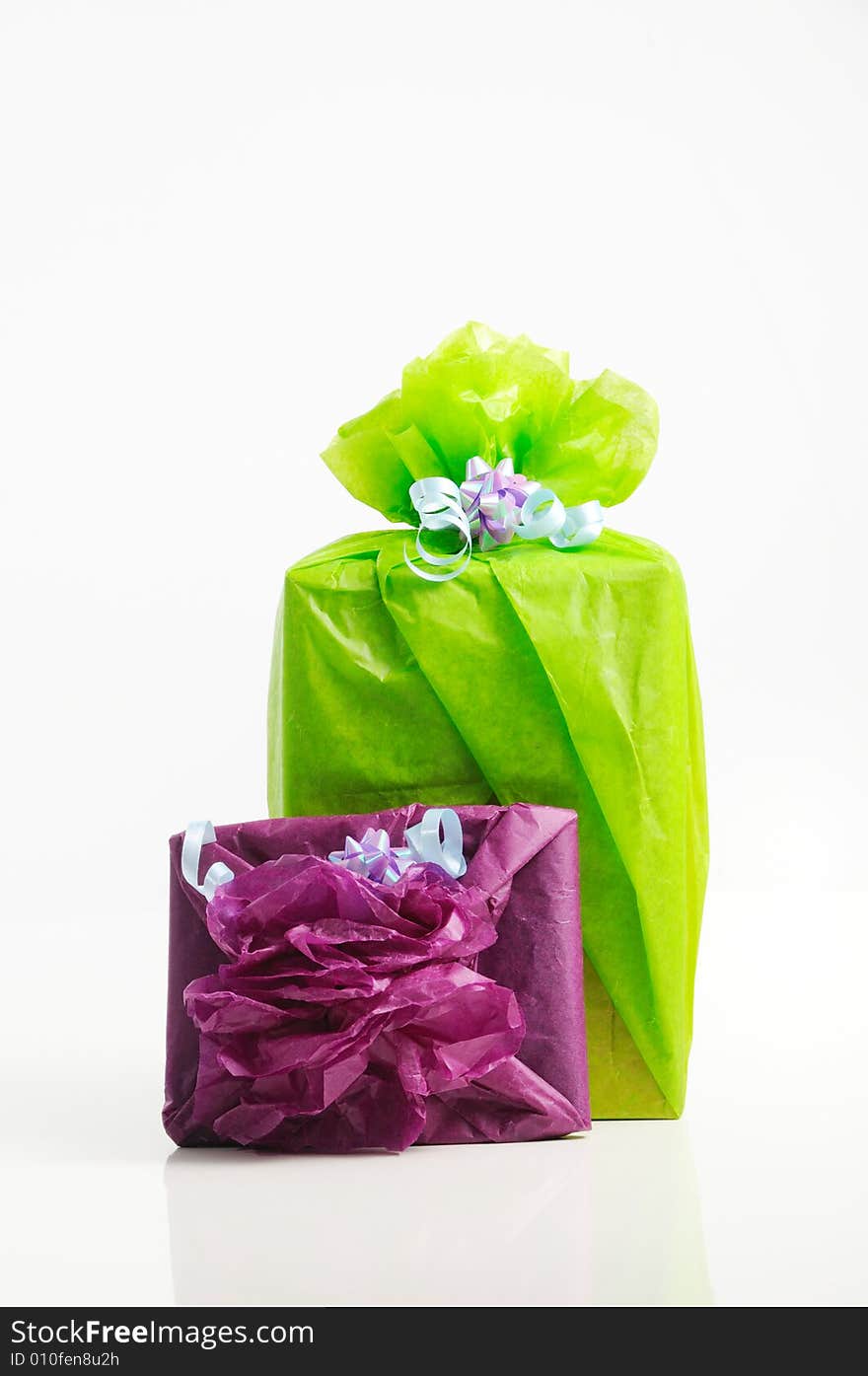 Two gift boxed wrapped in colorful papers - isolated. Two gift boxed wrapped in colorful papers - isolated