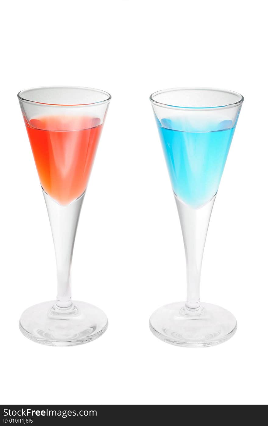 Two red and blue cocktail glasses isolated over white background. Two red and blue cocktail glasses isolated over white background