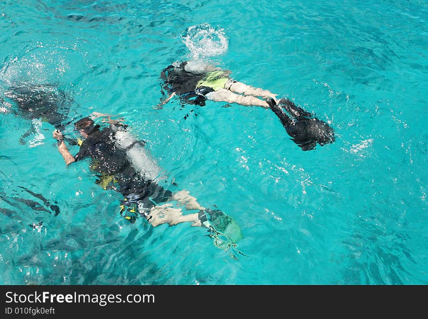 Group of scuba divers under water.