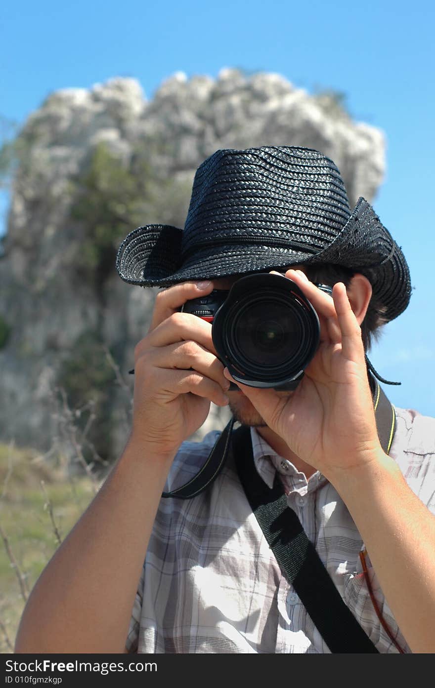 Portrait of young man using professional camera in nature background. Portrait of young man using professional camera in nature background