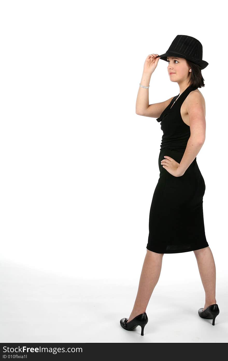 Teenage girl in top hat turned to the side with her hand on her hip. Teenage girl in top hat turned to the side with her hand on her hip