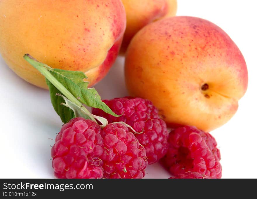 Close-up of raspberry with leaves and apricots. Close-up of raspberry with leaves and apricots