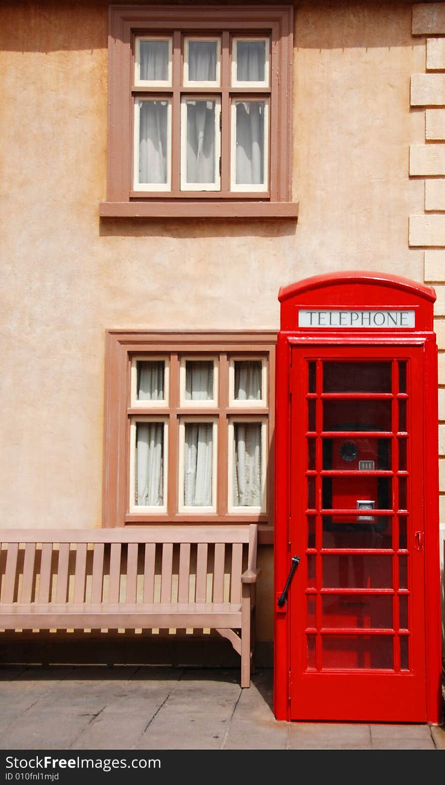 British telephone box in front of a houses