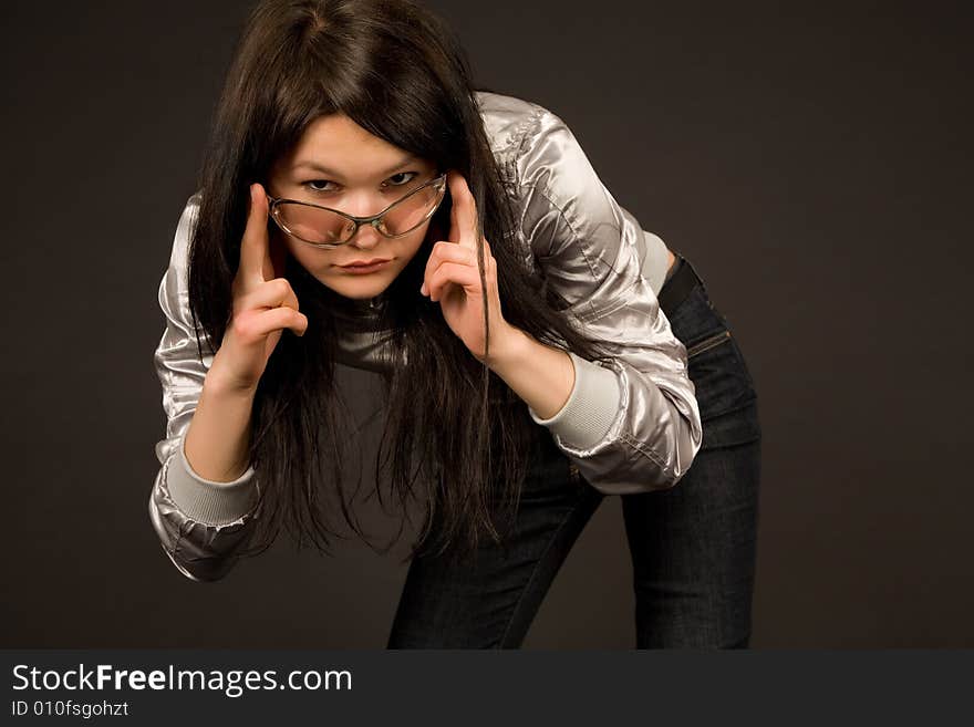 Young girl in fashion sunglasses, isolated on black background