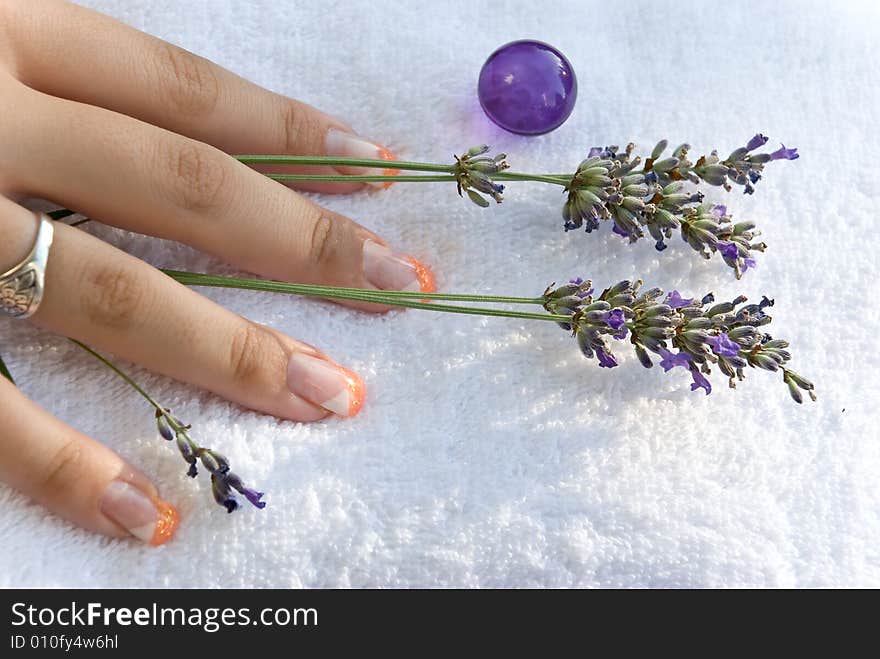 Women hand with lavender on the towel.