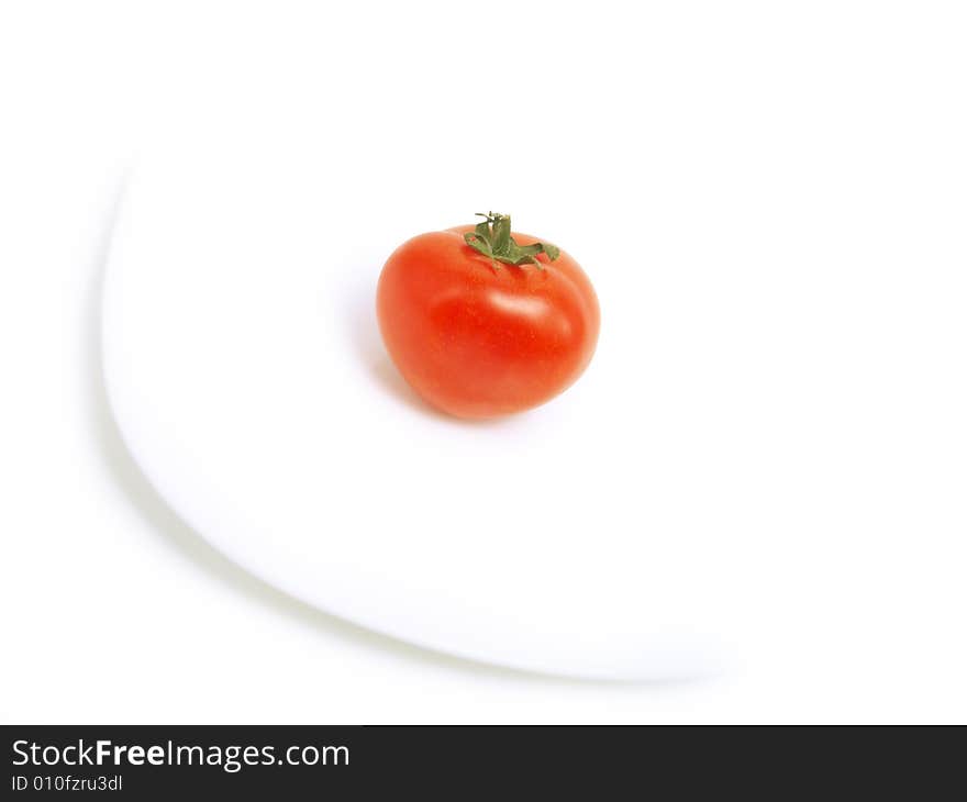 Red tomato on white plate and isolated on white background. Red tomato on white plate and isolated on white background