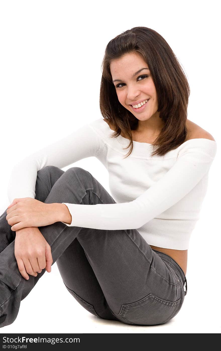 An attractive young woman posing casually in the studio. An attractive young woman posing casually in the studio