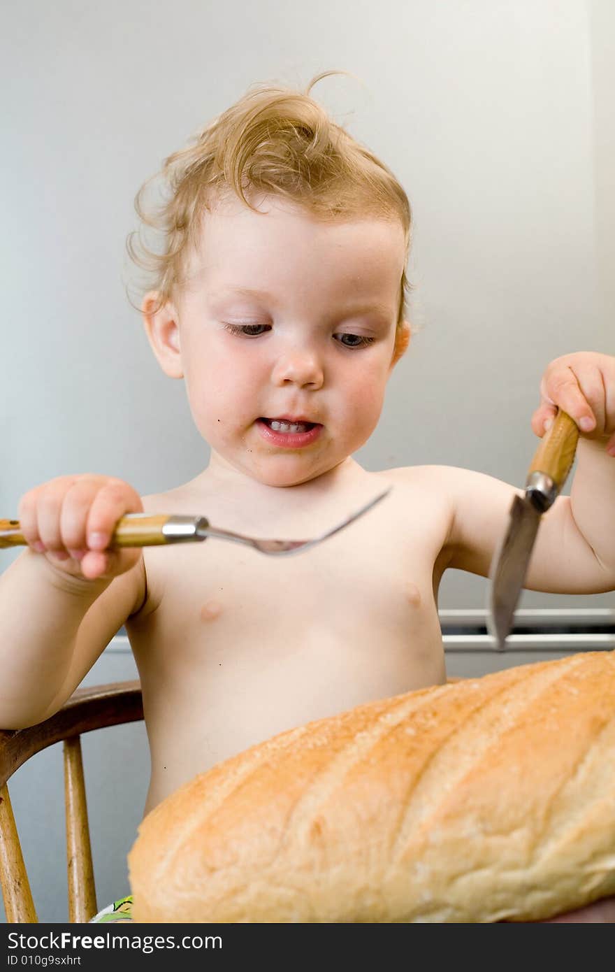 An image of baby-girl eating white bread. An image of baby-girl eating white bread