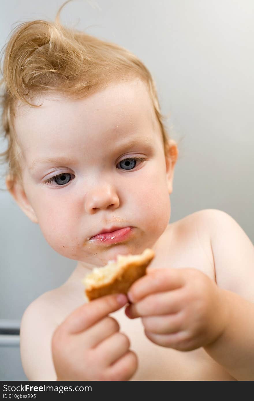 An image of baby eating white bread. An image of baby eating white bread