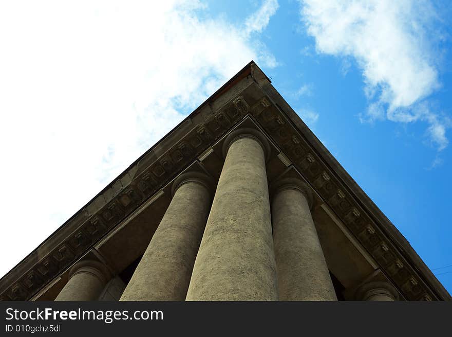 Column construction under blue sky with clouds