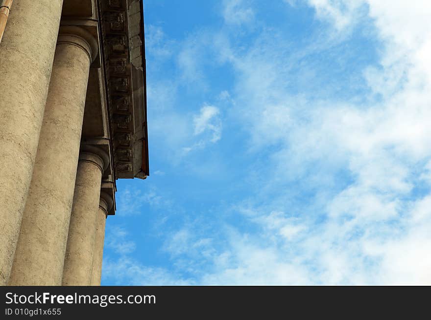 Column construction under blue sky with clouds