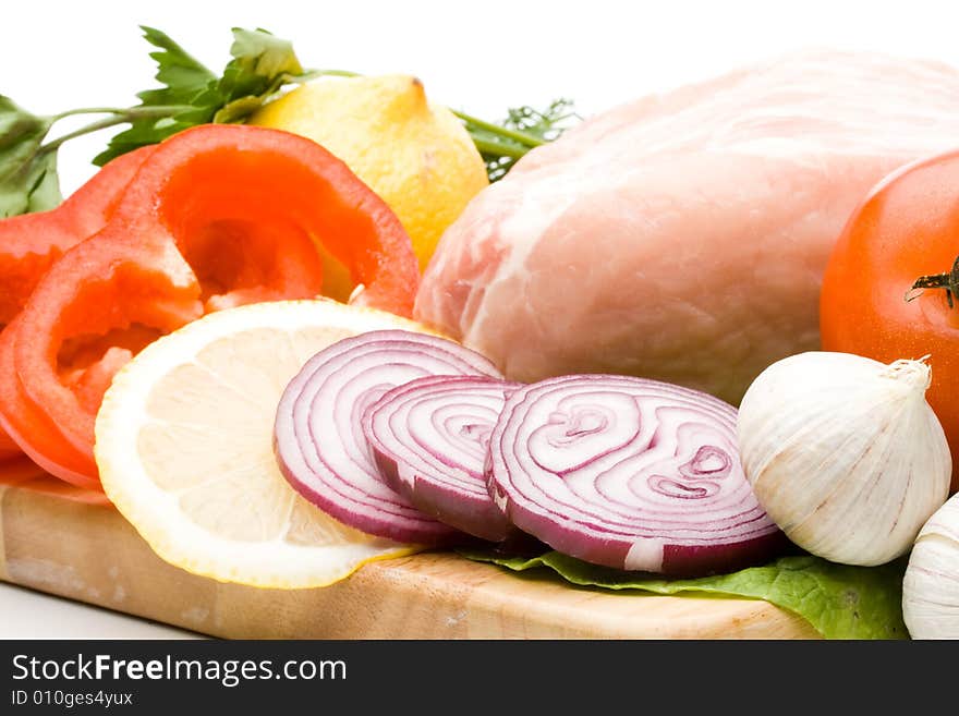 Fresh meat with vegetables on a white background. Close up.