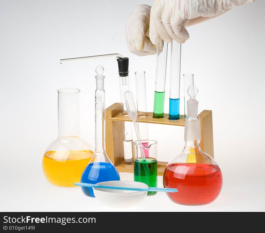 Various colorful glass laboratory ware on a white background. Various colorful glass laboratory ware on a white background