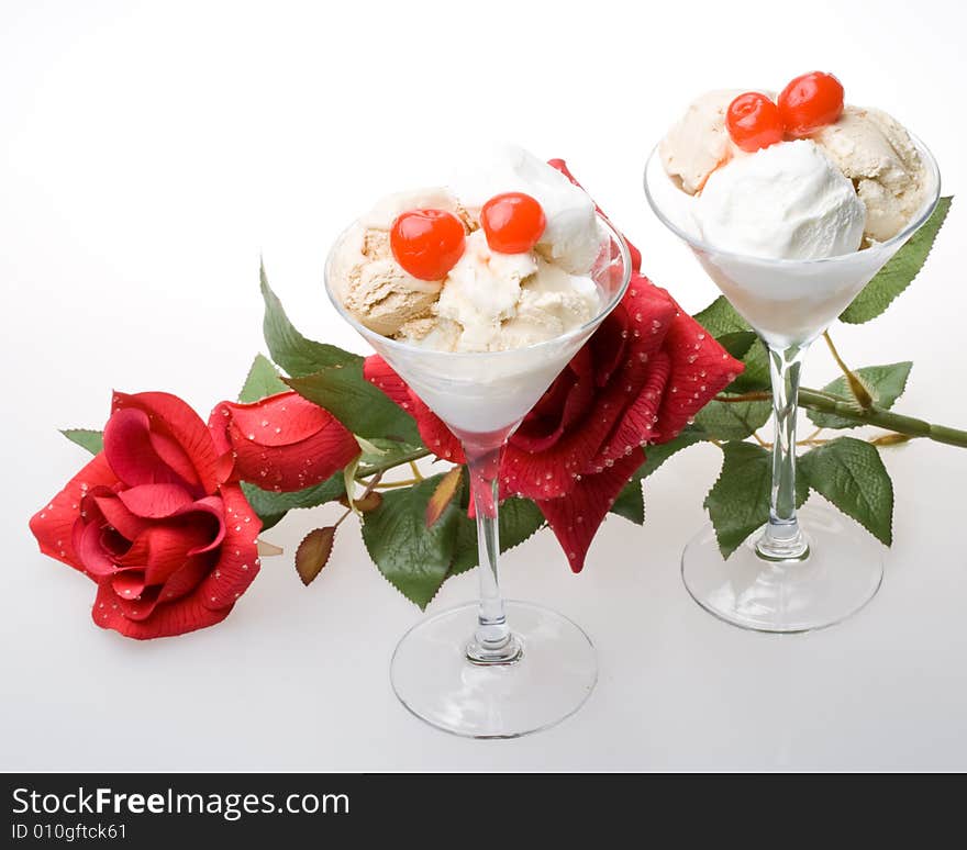 Ice-cream with a cherry in a glass on a white background. Ice-cream with a cherry in a glass on a white background.