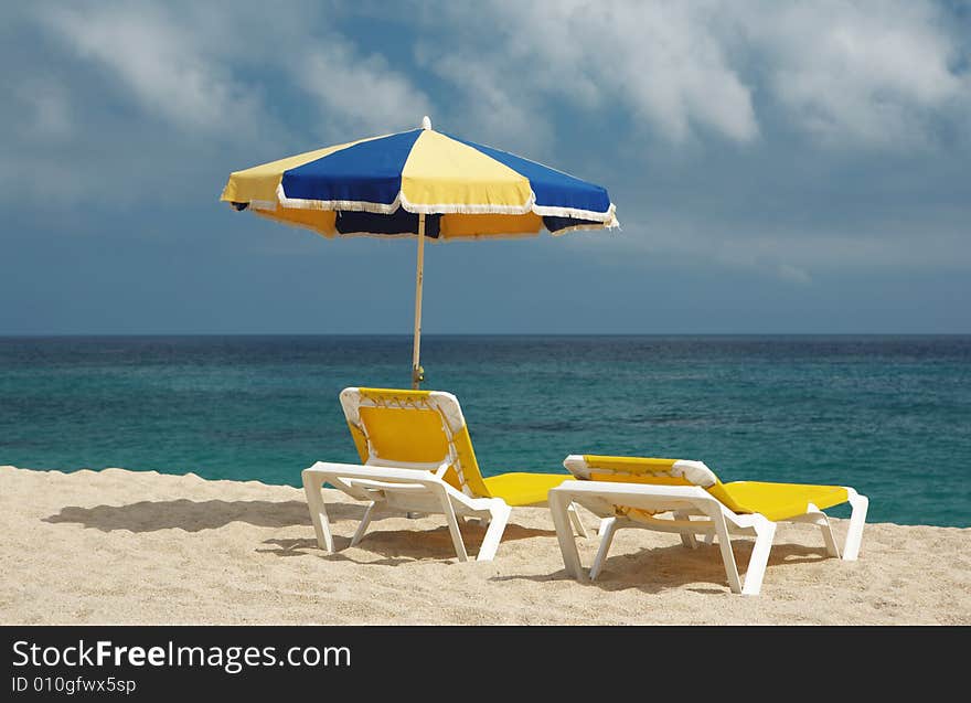 Two chairs and beach umbrella