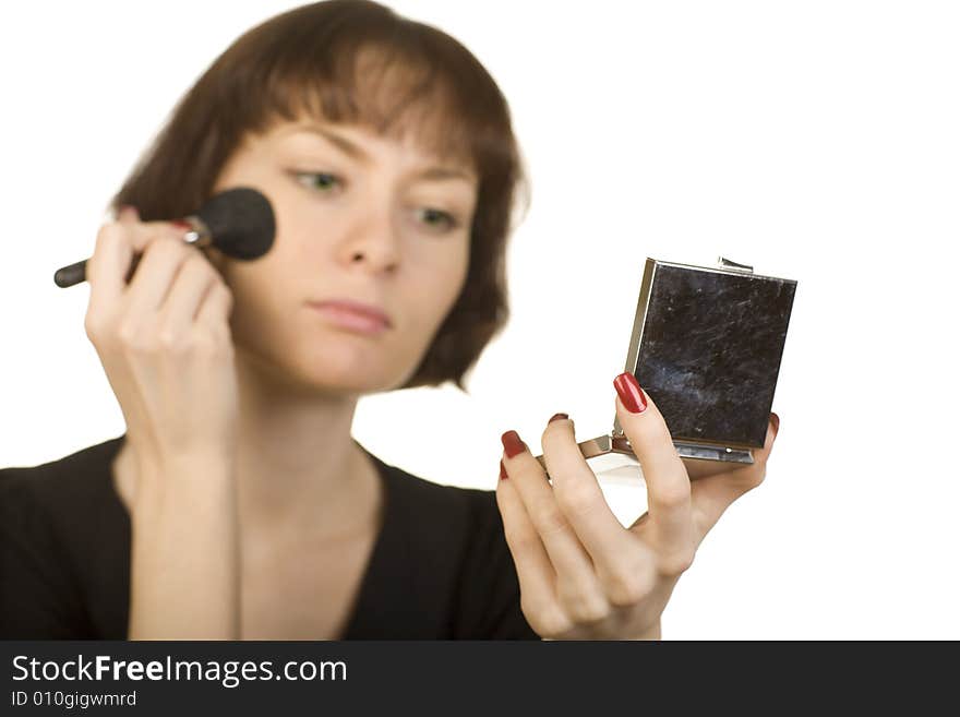 A photo of a young girl holding a powder compact. A photo of a young girl holding a powder compact