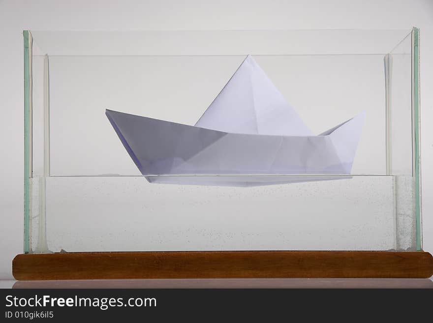 Paper boat in glass aquarium