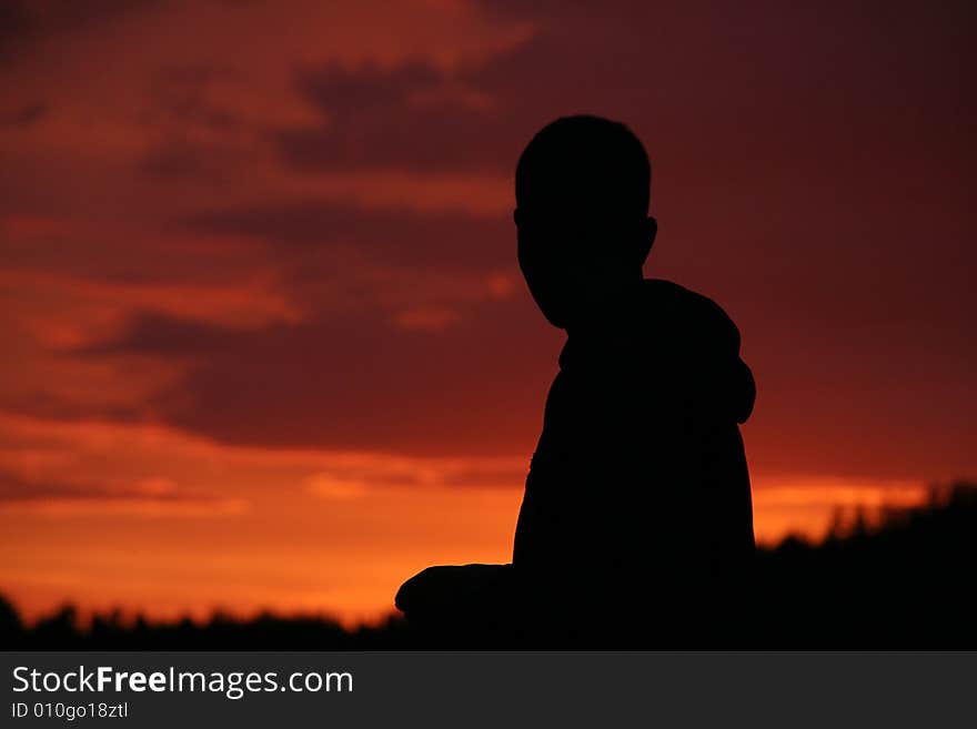 A man silhouette on a red sunset. A man silhouette on a red sunset