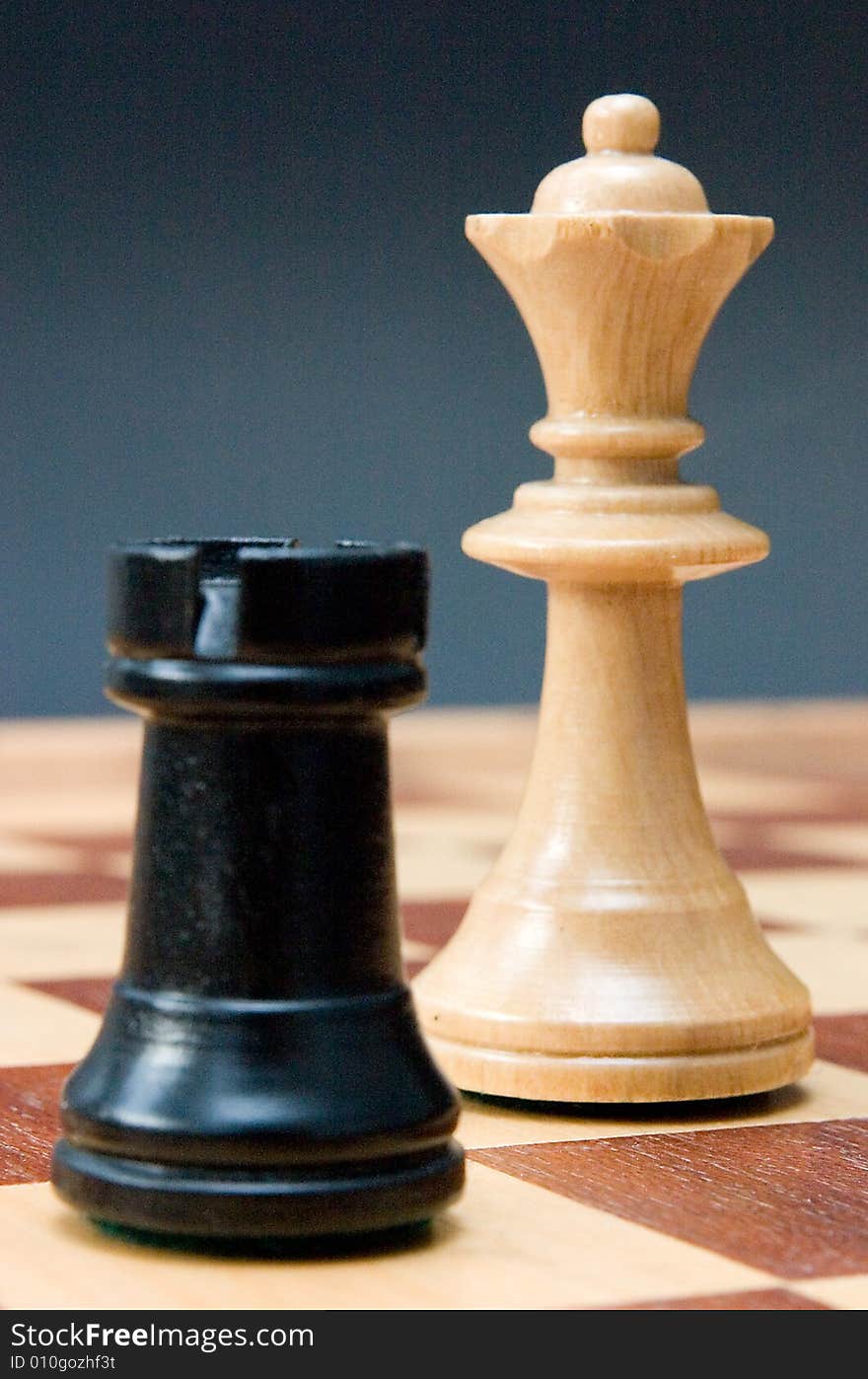 Chess - rook and queen on the board, blue background