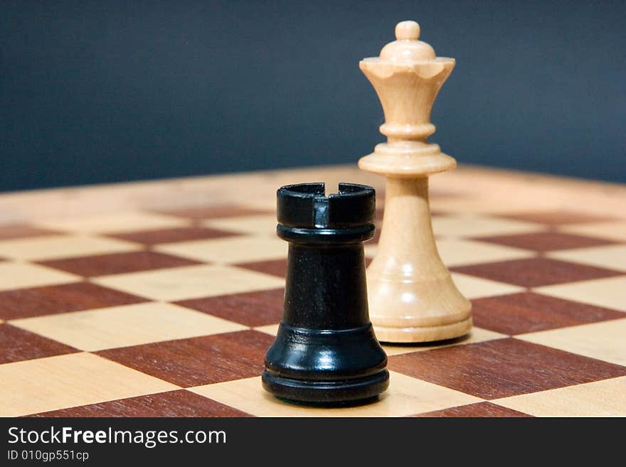 Chess - rook and queen on the board, blue background