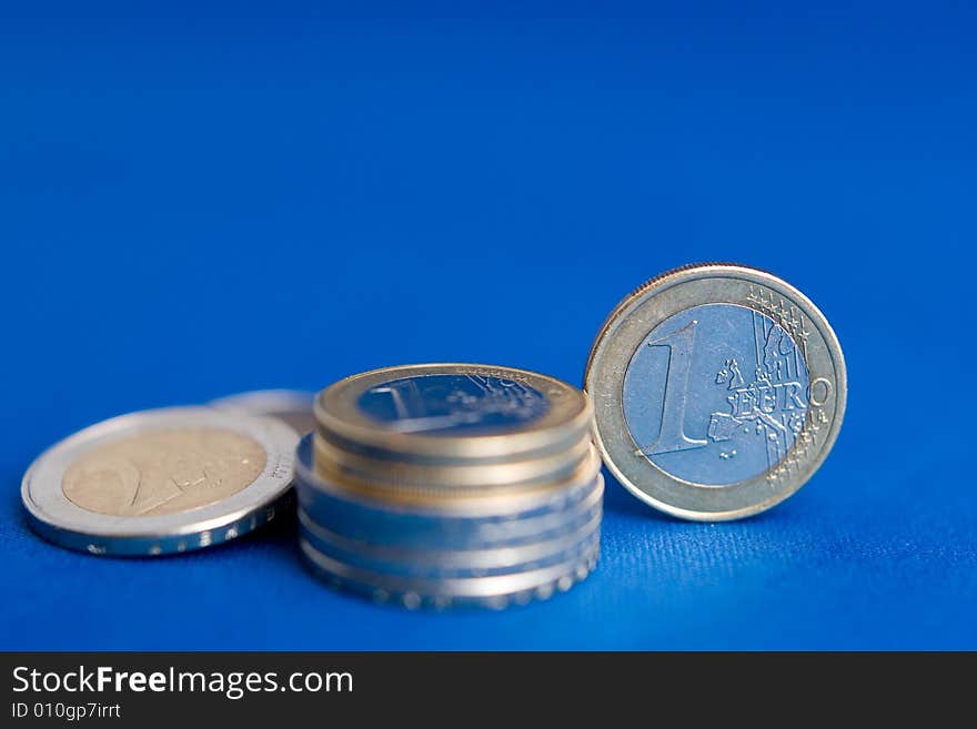 Some Euro coins and a blue backround. Some Euro coins and a blue backround