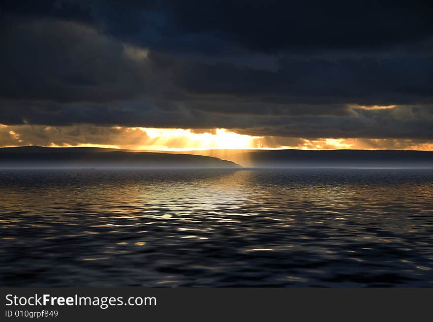 Sunset across the sea with ship in distance. Sunset across the sea with ship in distance.