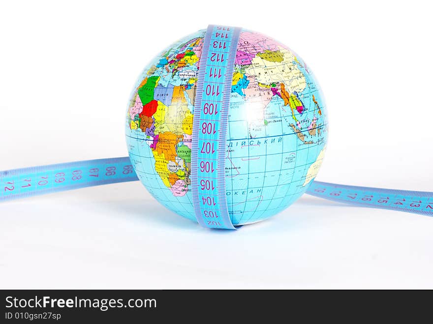 Measuring tape stretched across globe on white