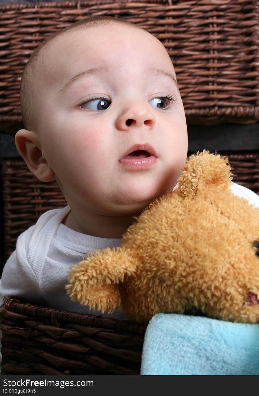 Six month old baby sitting infront of wooden drawers. Six month old baby sitting infront of wooden drawers