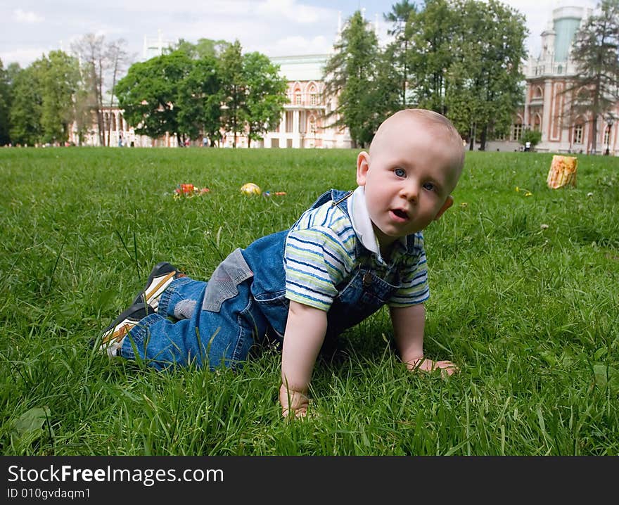 The kid playing on a grass in park