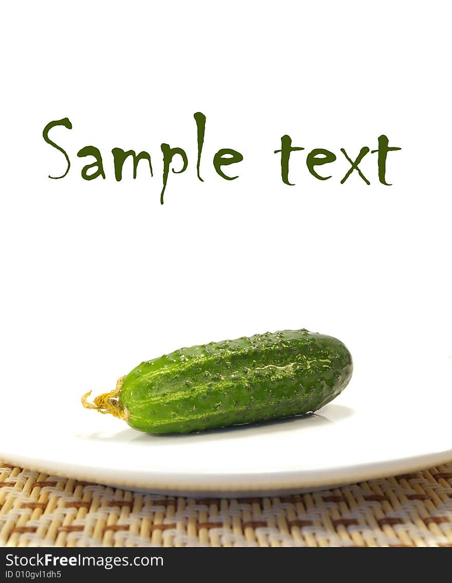 Ripe cucumber on a plate isolated on a white background