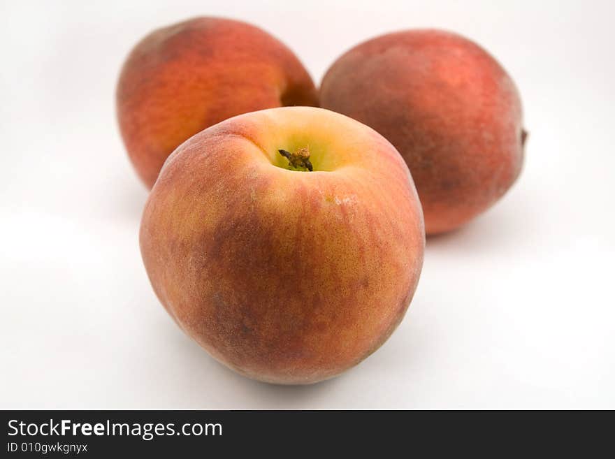 Three peaches isolated on white