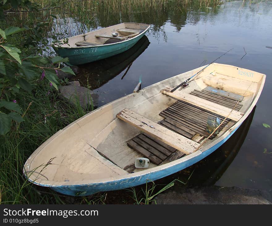 Two old boats at lake coast