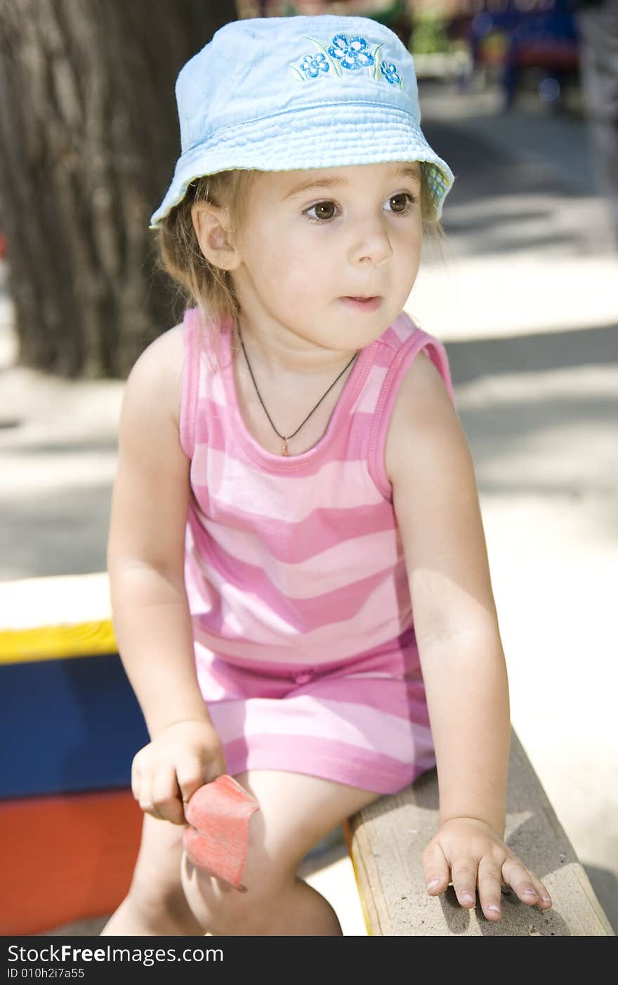 Little cute girl in sandbox