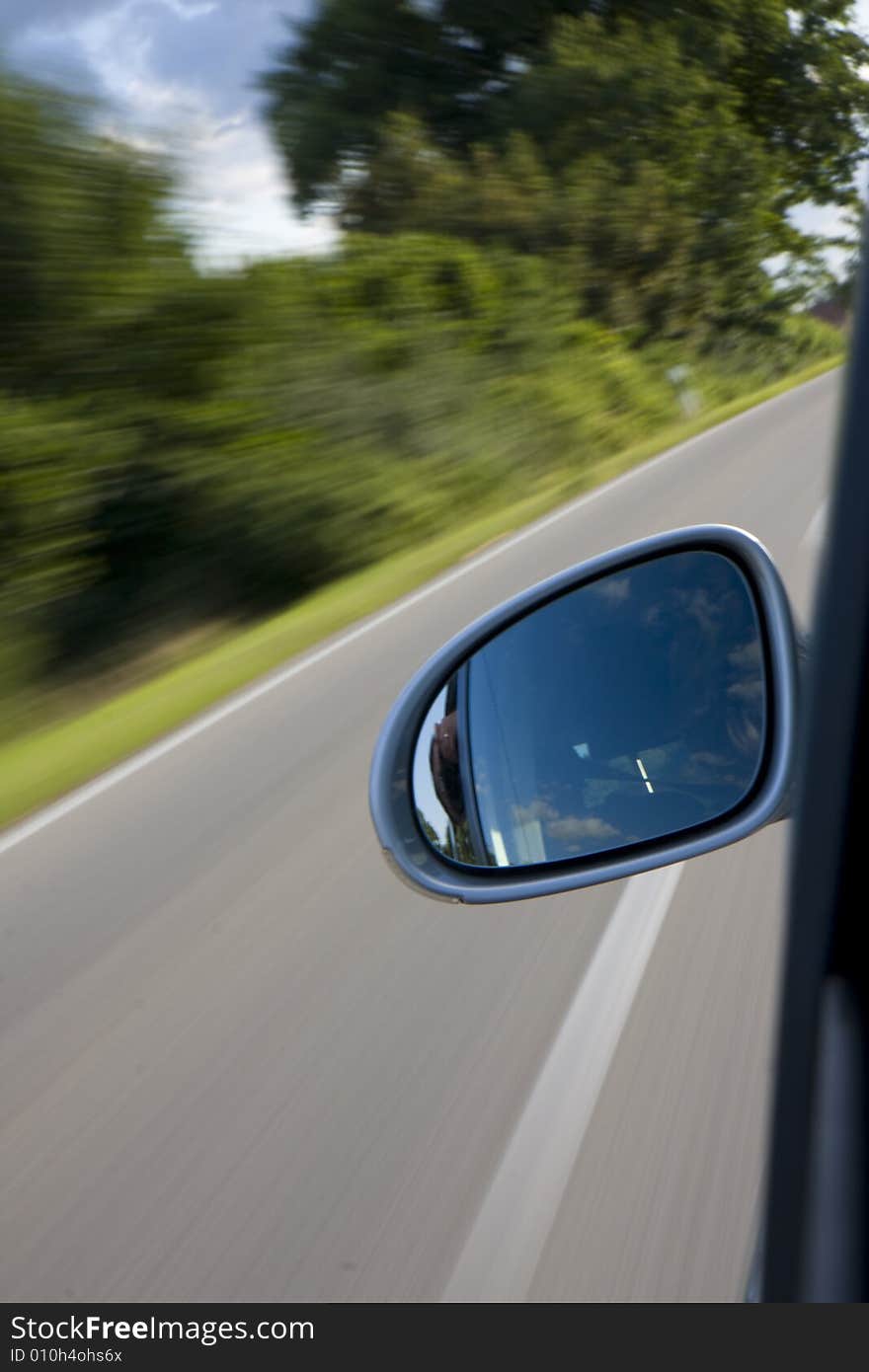 Detail of a car driving on a country road