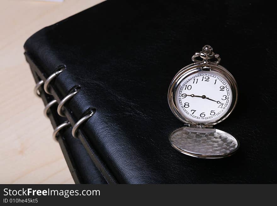 Pocket watch with balck notebook. Pocket watch with balck notebook