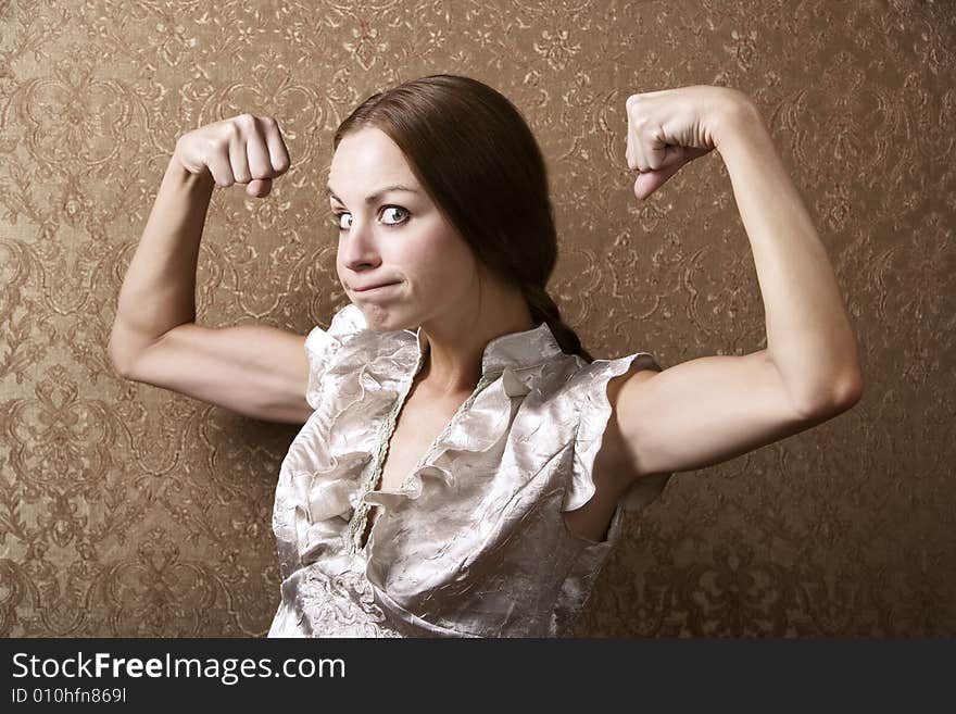 Portrait of a Pretty Young Woman Flexing Her Biceps