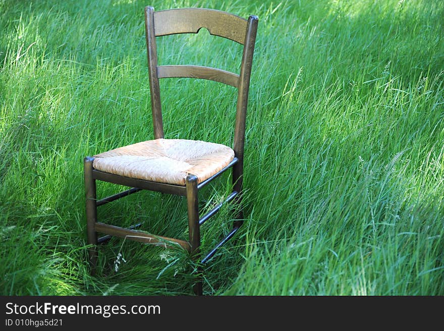 Chair isolated in a field of green grass.