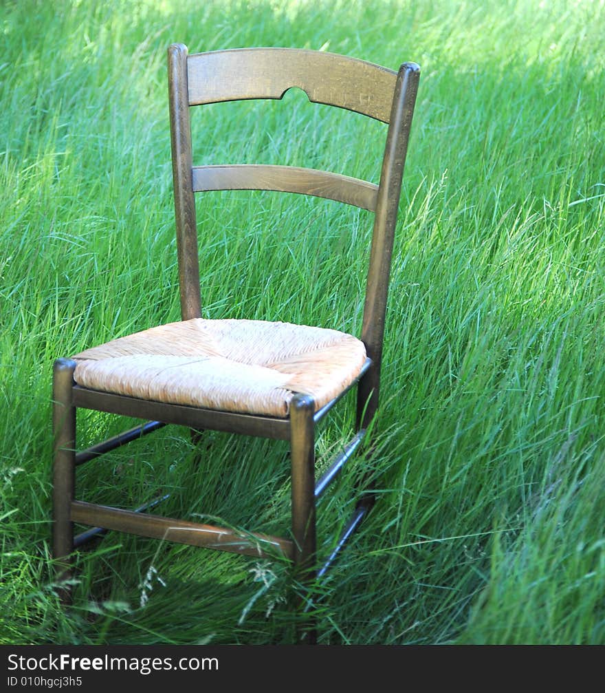 Chair isolated in a field of green grass.